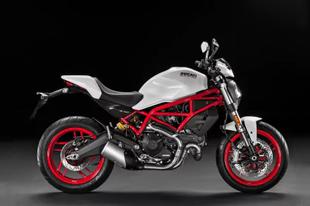Side profile of a white-and-red Ducati Monster 797 motorcycle vehicle (Ducati Monster) on a black backdrop — 4K Ultra HD PC desktop wallpaper/background.