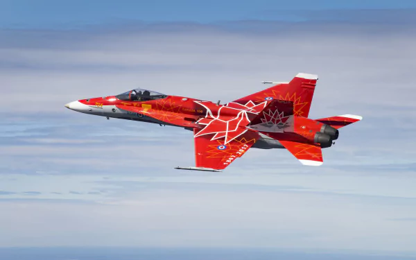 A McDonnell Douglas F/A-18 Hornet jet fighter in striking red military livery soars against a clear sky, captured in 4K Ultra HD resolution.
