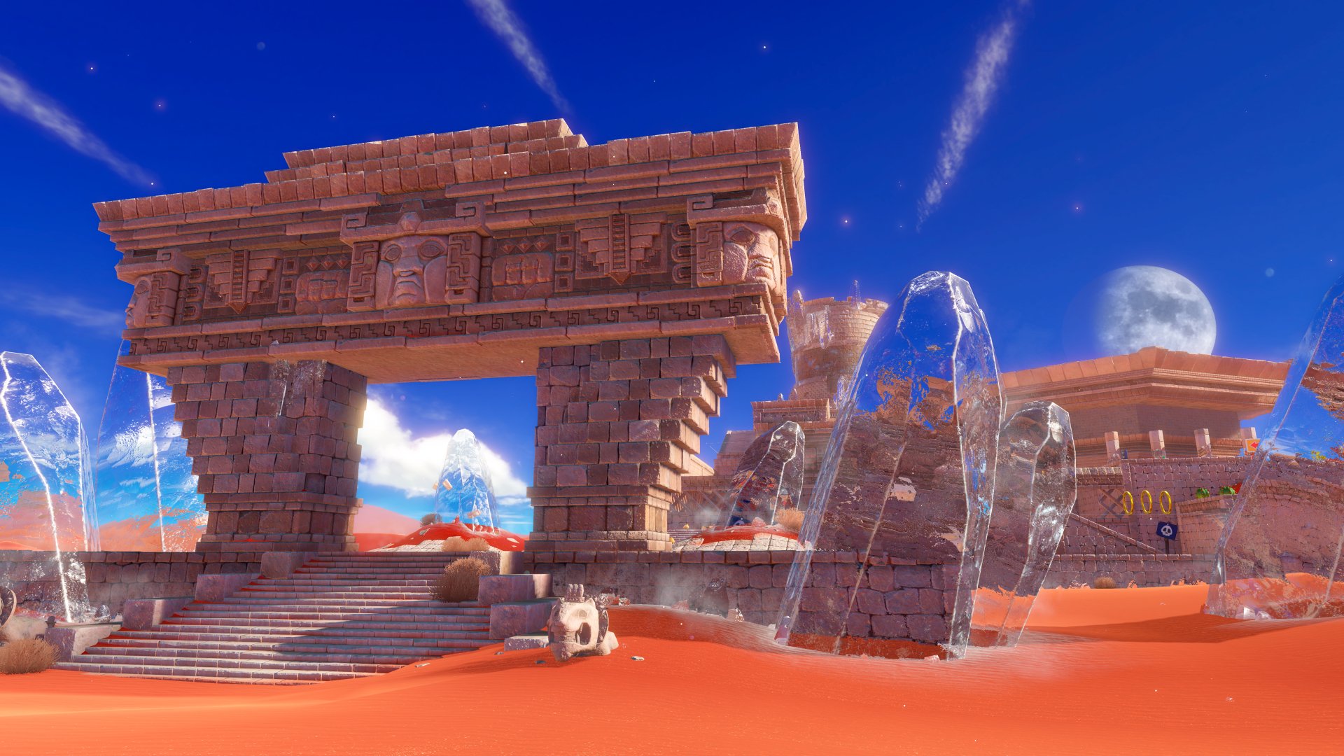 HD desktop wallpaper and background from the video game Super Mario Odyssey, featuring an ancient stone structure in a vibrant desert landscape with scattered ice formations under a clear blue sky.