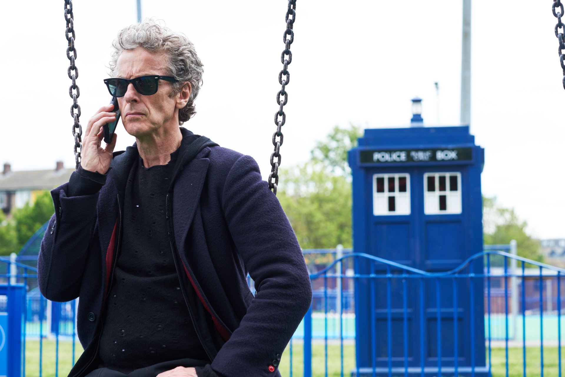 Graying man in sunglasses on phone beside a blue police box, 4K Ultra HD PC desktop wallpaper and background styled for Doctor Who (2005).