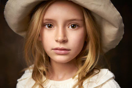Close-up photography of a child with brown eyes wearing a soft, wide-brimmed hat, captured in high definition for a PC desktop wallpaper background.