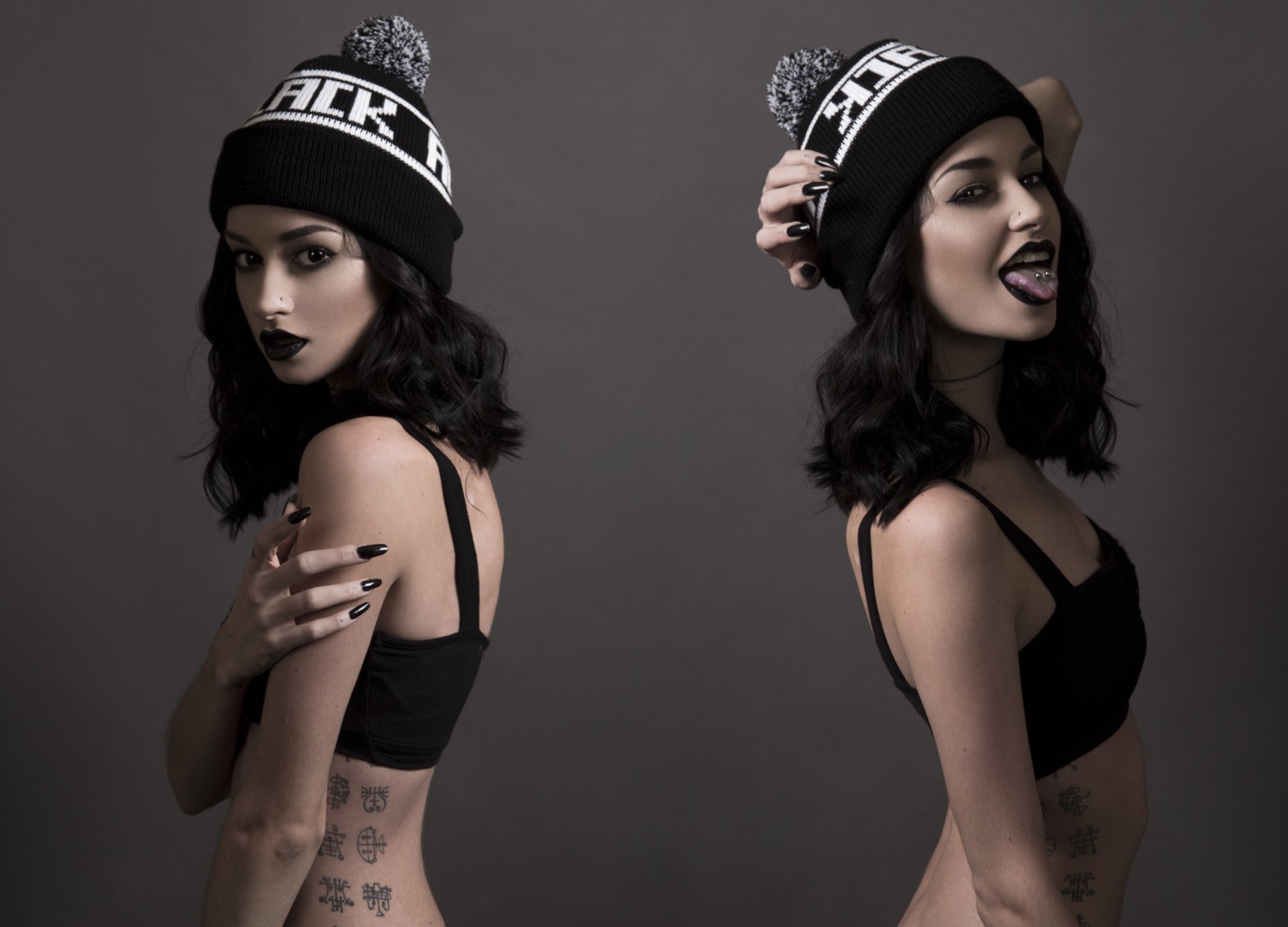 Gothic model Felice Fawn poses in black attire and a beanie, showcasing dark makeup and expressive looks against a muted gray background in this HD desktop wallpaper.