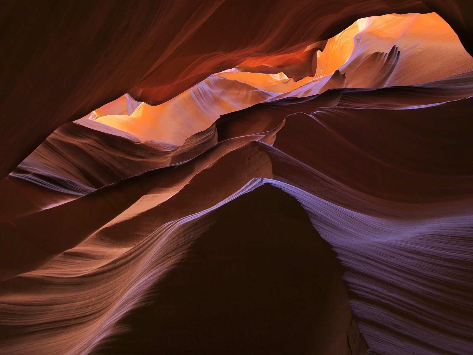 HD PC desktop wallpaper and background of Antelope Canyon: undulating sandstone walls in warm orange and cool purple light, a nature scene of layered rock curves and a narrow canyon sky.