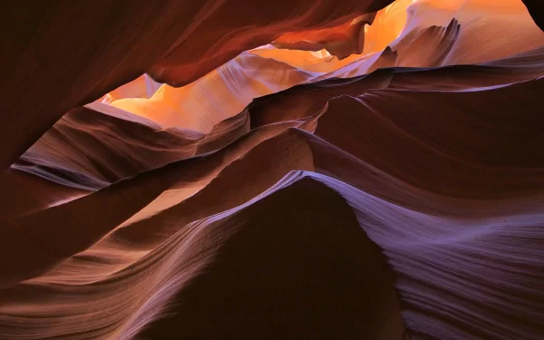 HD PC desktop wallpaper and background of Antelope Canyon: undulating sandstone walls in warm orange and cool purple light, a nature scene of layered rock curves and a narrow canyon sky.
