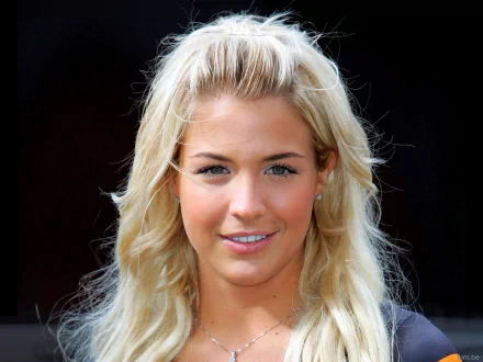 HD desktop wallpaper featuring a close-up portrait of celebrity Gemma Atkinson with blonde hair and a natural smile against a dark background.