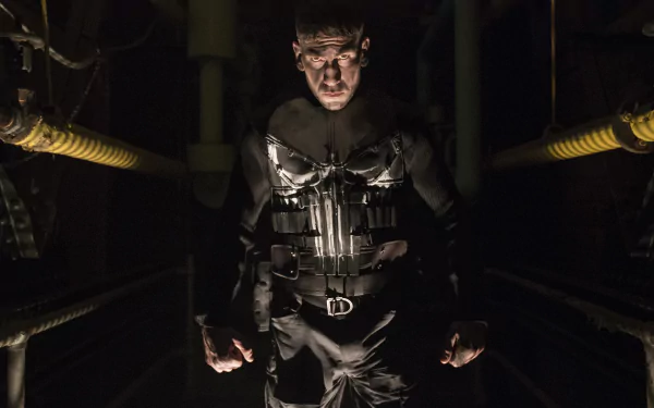 Jon Bernthal as the Punisher stands menacingly in shadows, showcasing his intense character from the TV show. This dramatic 4K Ultra HD image captures his fierce presence.