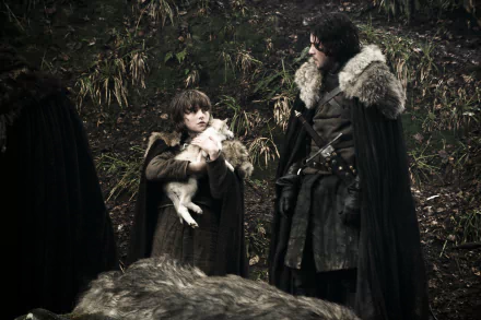 Game of Thrones 4K desktop wallpaper: Jon Snow and young Bran Stark in fur cloaks in a forest clearing, Bran cradling a direwolf pup.