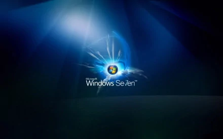 A high-definition desktop wallpaper featuring the Microsoft Windows 7 logo, illuminated against a blue background, showcasing a sleek and modern technology aesthetic.