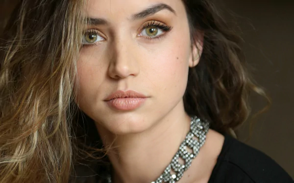 HD desktop wallpaper and background featuring Cuban actress Ana de Armas with green eyes and brunette hair, wearing a necklace.