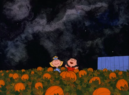 Linus van Pelt and Sally Brown laughing in a pumpkin patch beneath a starry sky from the movie It's the Great Pumpkin, Charlie Brown — 2K Quad HD PC desktop wallpaper.