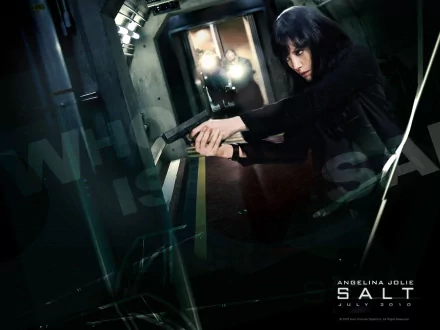 HD PC desktop wallpaper featuring Angelina Jolie aiming a gun in a dramatic scene from the movie Salt, showcasing intense action and suspense.