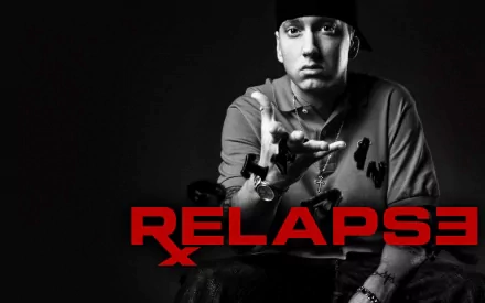 Black and white HD wallpaper featuring Eminem making a striking pose, with RELAPSE boldly displayed in red, capturing the essence of his impactful music career.