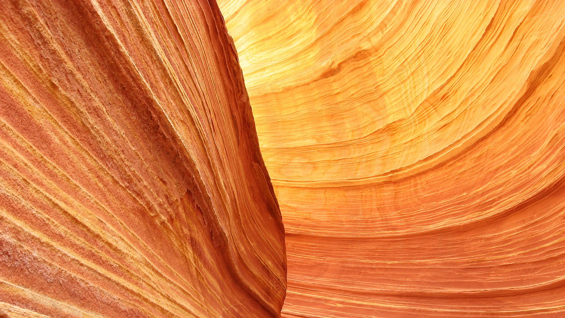 HD PC desktop wallpaper/background: Antelope Canyon landscape photography — flowing stone stripes and curved lines in warm orange patterns with a sliver of sky.