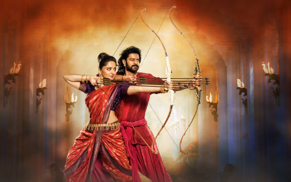 HD desktop wallpaper from the movie Baahubali 2: The Conclusion, featuring two characters drawing bows together against a dramatic, fiery background.