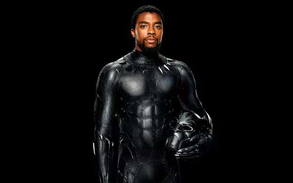 HD desktop wallpaper and background featuring Chadwick Boseman as Black Panther, standing in his iconic suit against a black background while holding his helmet.