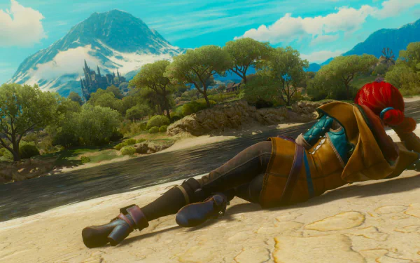 HD desktop wallpaper featuring Triss Merigold from The Witcher 3: Wild Hunt, lying on a riverbank with a scenic mountain and castle in the background.