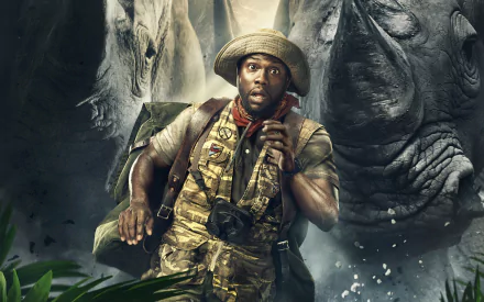 HD desktop wallpaper of Kevin Hart in Jumanji: Welcome to the Jungle, featuring him in an adventurous scene with rhinos in the background.