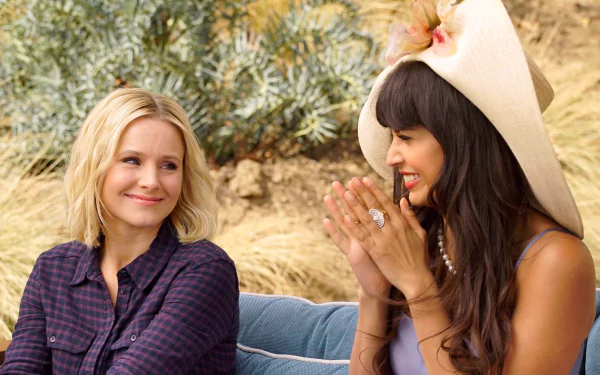 HD desktop wallpaper featuring two smiling women from The Good Place TV series, set against a desert-like backdrop.