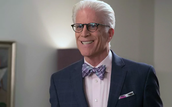 HD wallpaper of a character from The Good Place portrayed by actor Ted Danson, smiling in a suit with a bow tie.