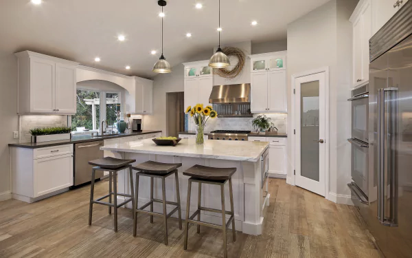 Modern kitchen with white cabinetry, island seating, stainless steel appliances, and hardwood floors, captured in stunning 4K Ultra HD for a sleek PC desktop background.
