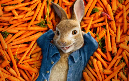 HD desktop wallpaper featuring Peter Rabbit lounging on a bed of vibrant orange carrots, capturing the playful essence of the Peter Rabbit movie.