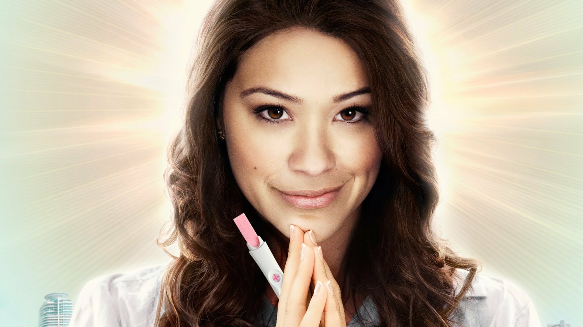 HD desktop wallpaper from Jane the Virgin featuring a smiling woman with a glowing background.