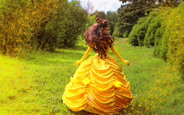 A woman in a vibrant yellow Beauty and the Beast (1991) cosplay dress stands in a lush green field under a bright sky, captured in 4K Ultra HD for a PC desktop wallpaper.