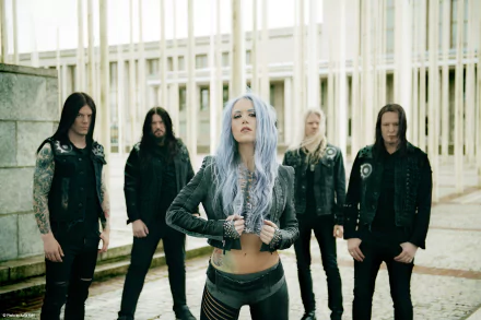 HD desktop wallpaper of Alissa White-Gluz with her band Arch Enemy, tagged with metal music. The image features the band standing outdoors, with Alissa in the forefront.