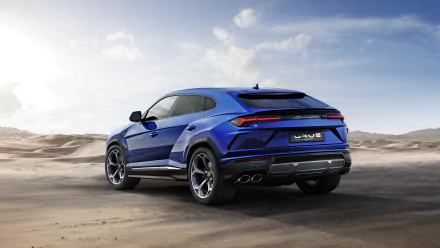 HD desktop wallpaper featuring a striking blue Lamborghini Urus SUV against a scenic desert backdrop.