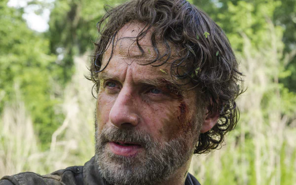 4K Ultra HD PC desktop wallpaper: close-up of a bloodied, bearded man in the woods, gritty TV show The Walking Dead aesthetic.