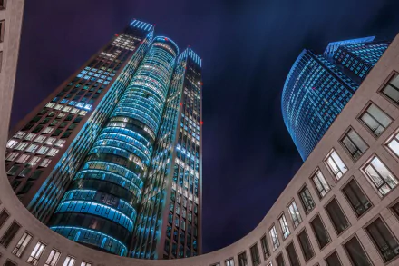 Tower 185 skyscraper in Frankfurt, Germany at night, blue-lit modern architecture photographed for an HD PC desktop wallpaper background.