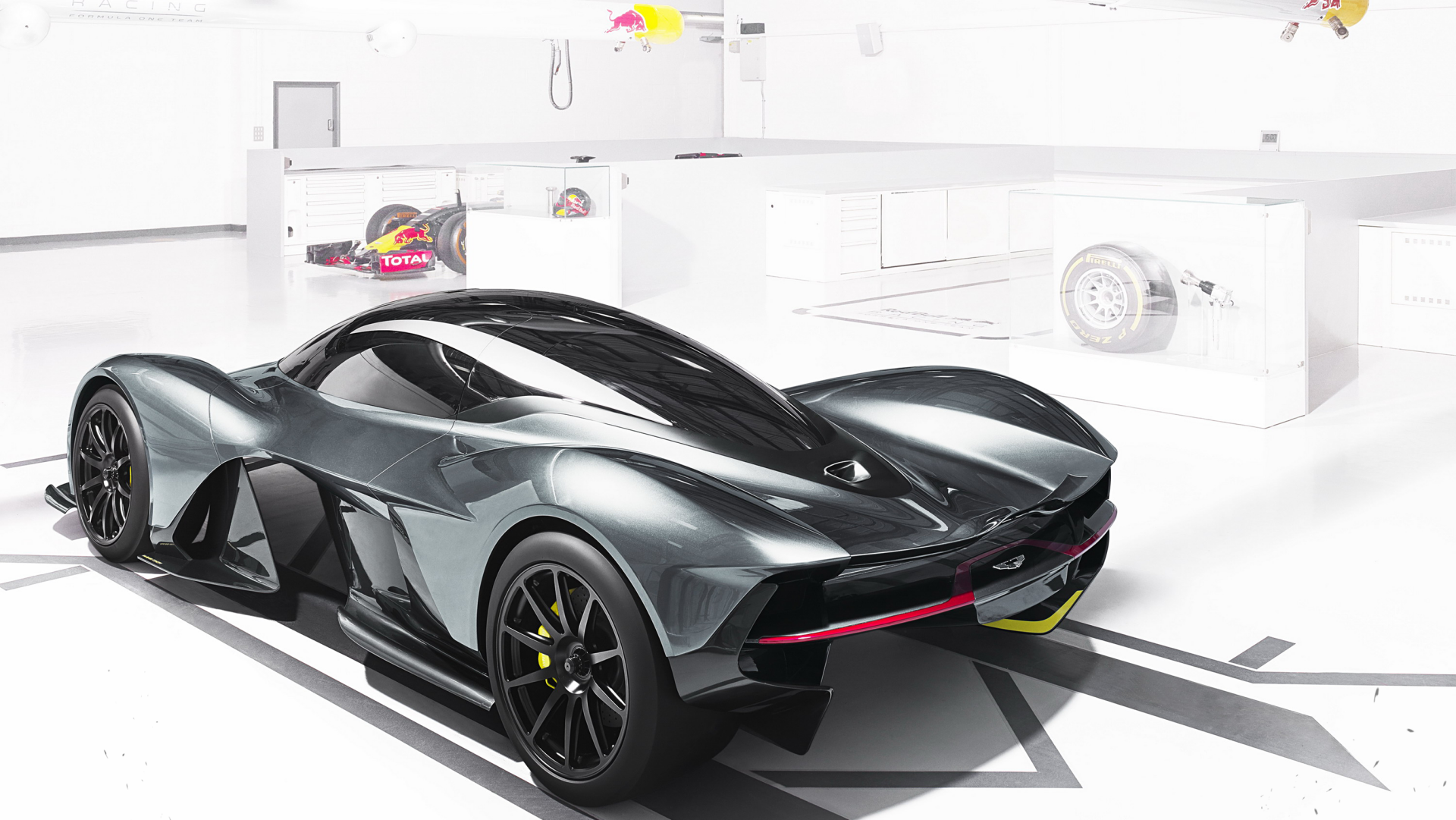2K Quad HD PC desktop wallpaper: Aston Martin Valkyrie hybrid supercar in a white studio, sleek gray aerodynamic vehicle with black wheels and red accent.