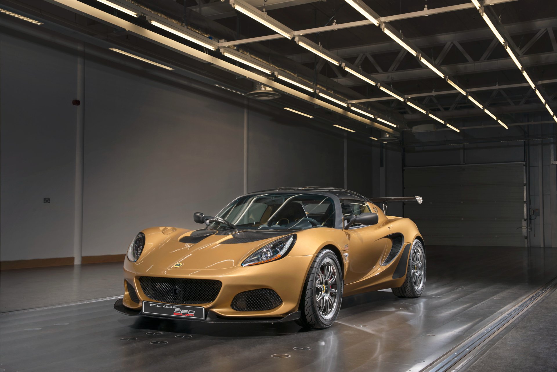 Orange Lotus Elise supercar showcased in a modern garage, captured in 4K Ultra HD for a striking PC desktop wallpaper and background.