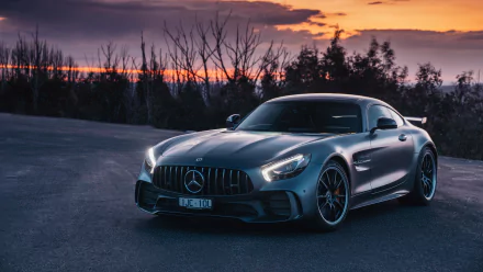 Silver Mercedes-AMG GT supercar parked on an open road at sunset, captured in stunning 4K Ultra HD as a striking PC desktop wallpaper and background.