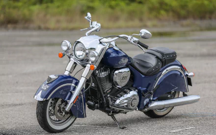 A blue Indian Chief Classic motorcycle parked on a paved surface, showcased as a high-definition PC desktop wallpaper background.
