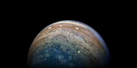 HD desktop wallpaper featuring a stunning sci-fi depiction of Jupiter's surface against the blackness of space.