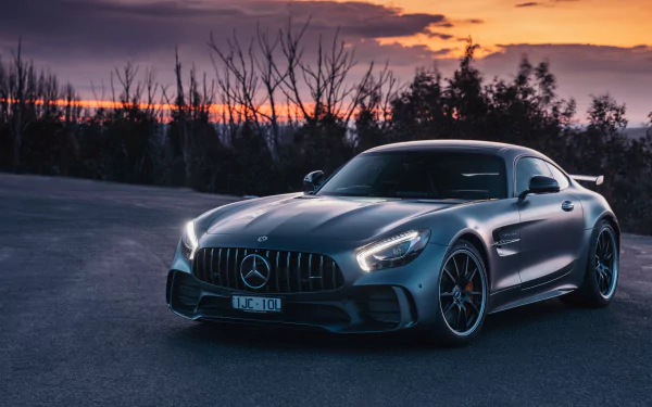 Silver Mercedes-AMG GT supercar parked on an open road at sunset, captured in stunning 4K Ultra HD as a striking PC desktop wallpaper and background.
