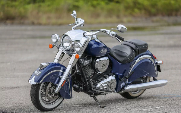 A blue Indian Chief Classic motorcycle parked on a paved surface, showcased as a high-definition PC desktop wallpaper background.