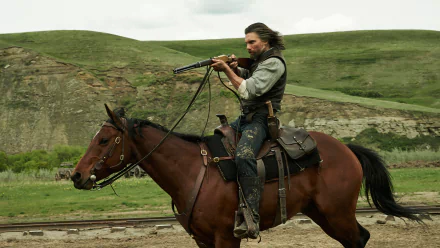 HD PC desktop wallpaper/background from TV show Hell on Wheels: a bearded rider on horseback aiming a rifle across rolling green plains.