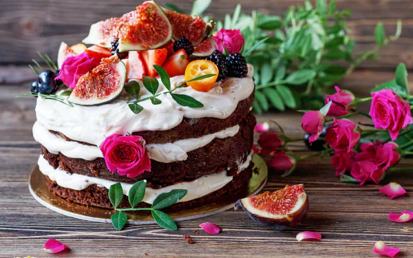 HD PC desktop wallpaper - still life of a rustic layered cake topped with figs, berries and pink roses, surrounded by rose petals and greenery on a wooden background.
