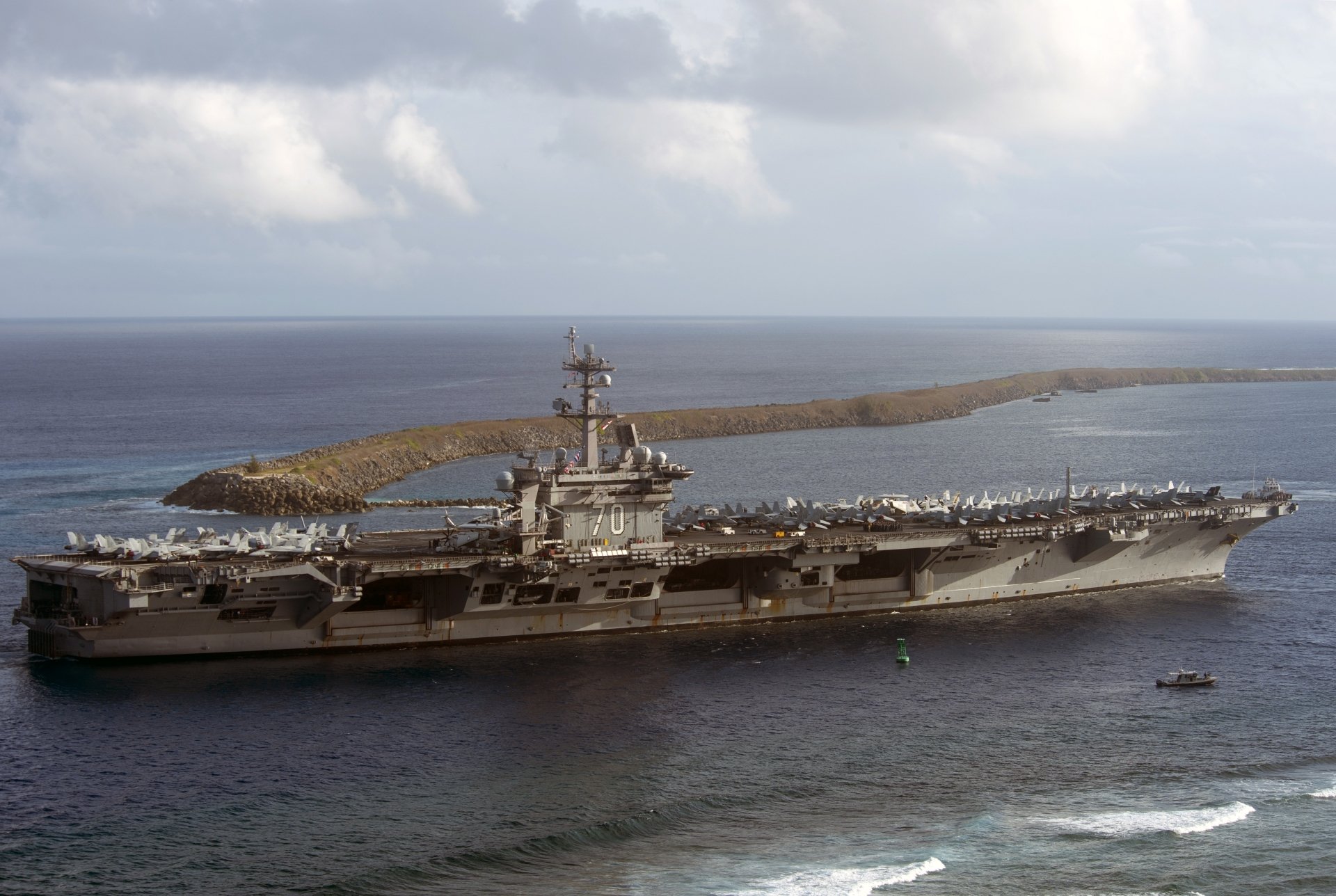 An impressive view of the USS Carl Vinson (CVN-70), an aircraft carrier and warship, set against a vast horizon and serene waters, captured in stunning 4K Ultra HD resolution.
