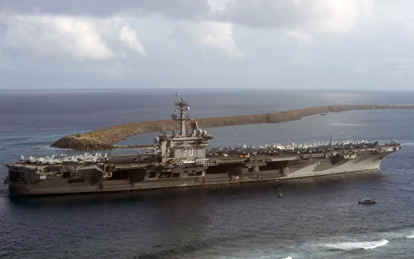 An impressive view of the USS Carl Vinson (CVN-70), an aircraft carrier and warship, set against a vast horizon and serene waters, captured in stunning 4K Ultra HD resolution.