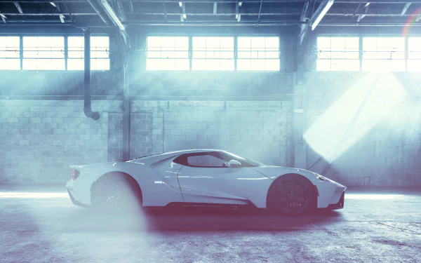 White Ford GT supercar showcased in a spacious, light-filled industrial warehouse, presented as an 8K Ultra HD PC desktop wallpaper and background.
