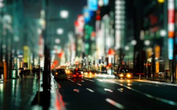 A vibrant night cityscape with blurred lights and moving cars, creating a cool, dynamic atmosphere. This HD photography makes an engaging desktop wallpaper and background.