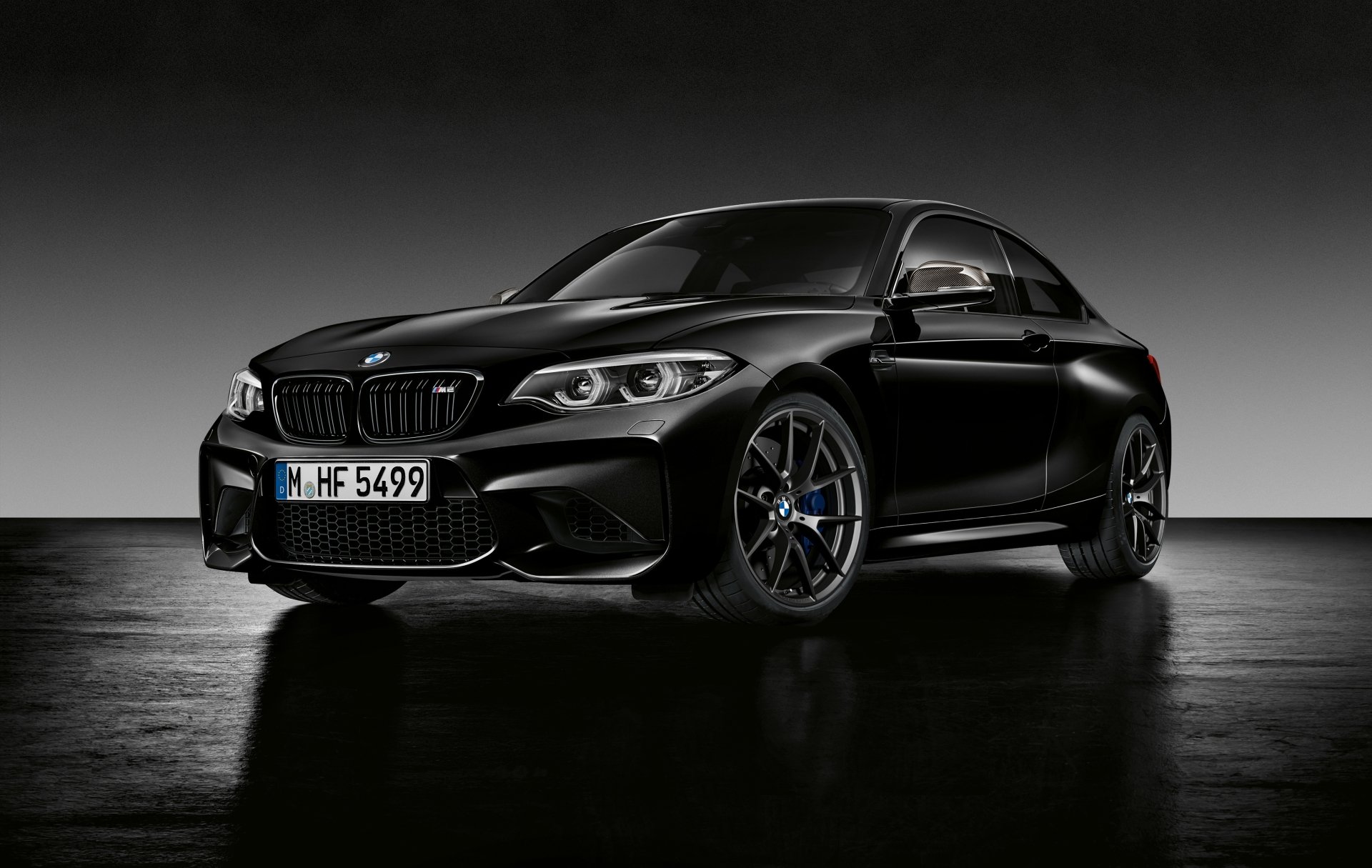 Black BMW M2 sports car showcased in sleek 4K Ultra HD, set against a minimalist dark background, highlighting its bold design and performance features.
