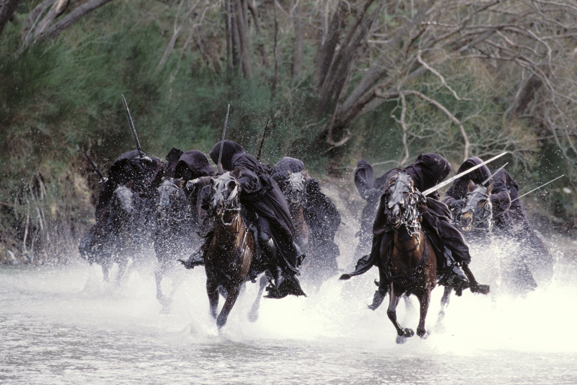 Nazgûl in dark cloaks on horseback charging through a river, captured from The Lord of the Rings: The Fellowship of the Ring, HD PC desktop wallpaper and background.