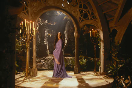HD PC desktop wallpaper featuring Liv Tyler as Arwen Evenstar from the movie The Lord of the Rings: The Fellowship of the Ring, in an elegant, candlelit elven setting.