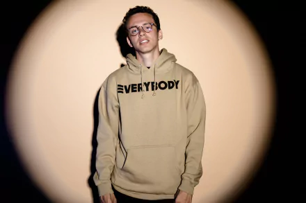 HD desktop wallpaper featuring a person in a hoodie with 'EVERYBODY' text, against a spotlight background, encapsulating a theme of logic.