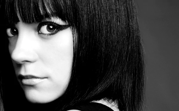 Black and white close-up of singer Lily Allen's face with striking eyeliner, designed as an HD PC desktop wallpaper background.