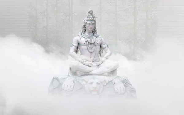 HD desktop wallpaper of a serene Shiva statue, a prominent deity in Hinduism, surrounded by mist with a subtle forest background, reflecting religious and spiritual symbolism.